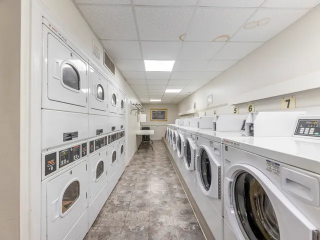 a view of washer and dryer with kitchen in the background