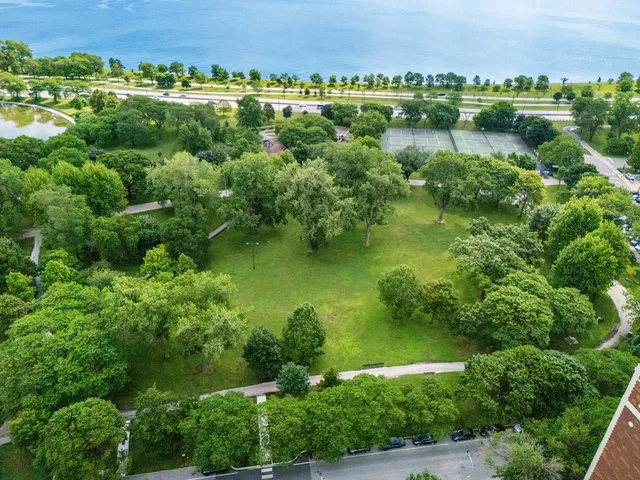 an aerial view of a houses with a lake view