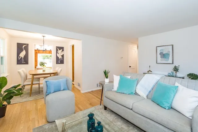 a living room with furniture and painting on the wall