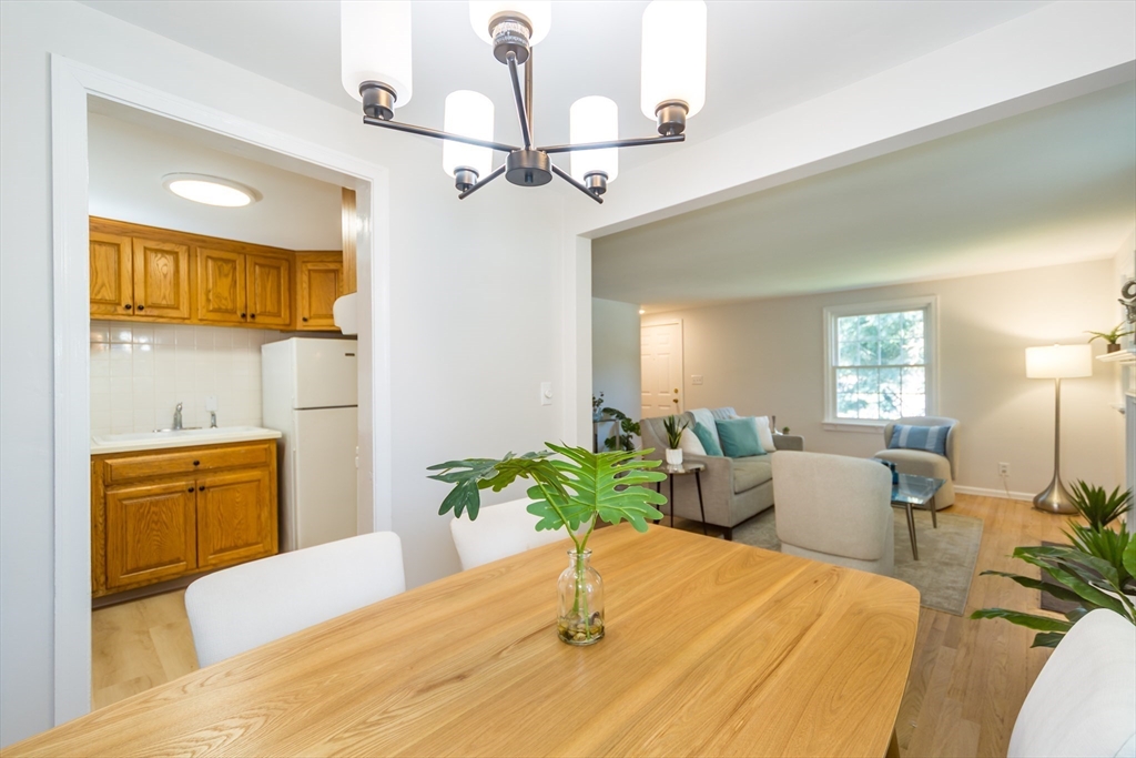 6 MacArthur Road Natick, MA 01760 - Photo 9 of 31 a bedroom with a bed and chandelier