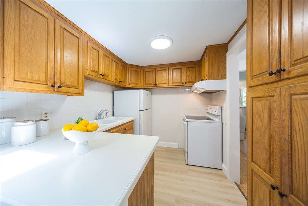 6 MacArthur Road Natick, MA 01760 - Photo 10 of 31 a kitchen with stainless steel appliances granite countertop a sink and cabinets