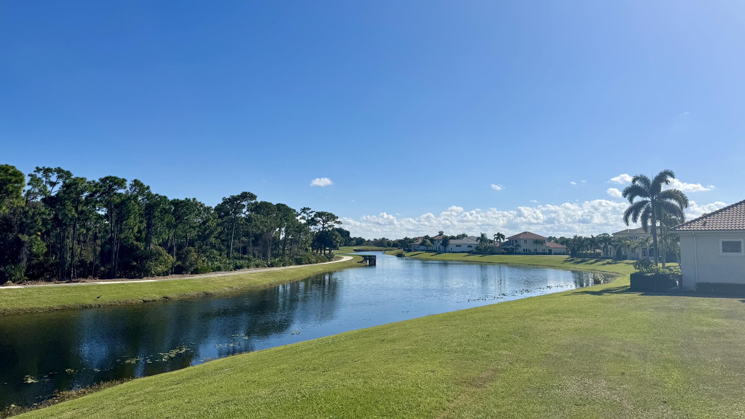 158 Southeast Rio Angelica Port St. Lucie, FL 34984 - Photo 2 of 12 a view of a lake with houses