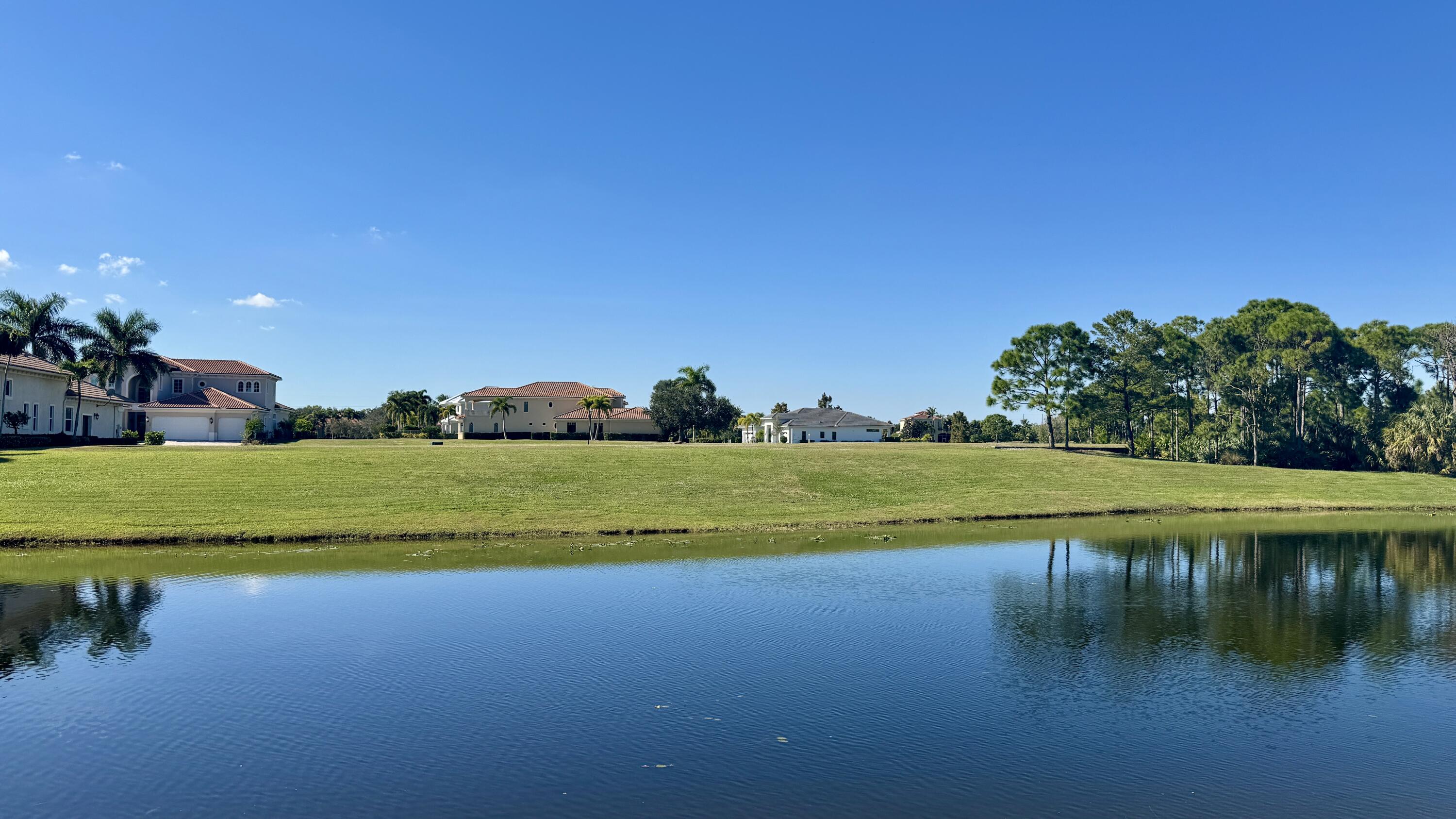 158 Southeast Rio Angelica Port St. Lucie, FL 34984 - Photo 8 of 12 a view of a lake with houses in the background