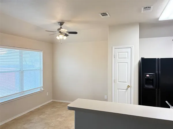 a view of room with a ceiling fan and a window