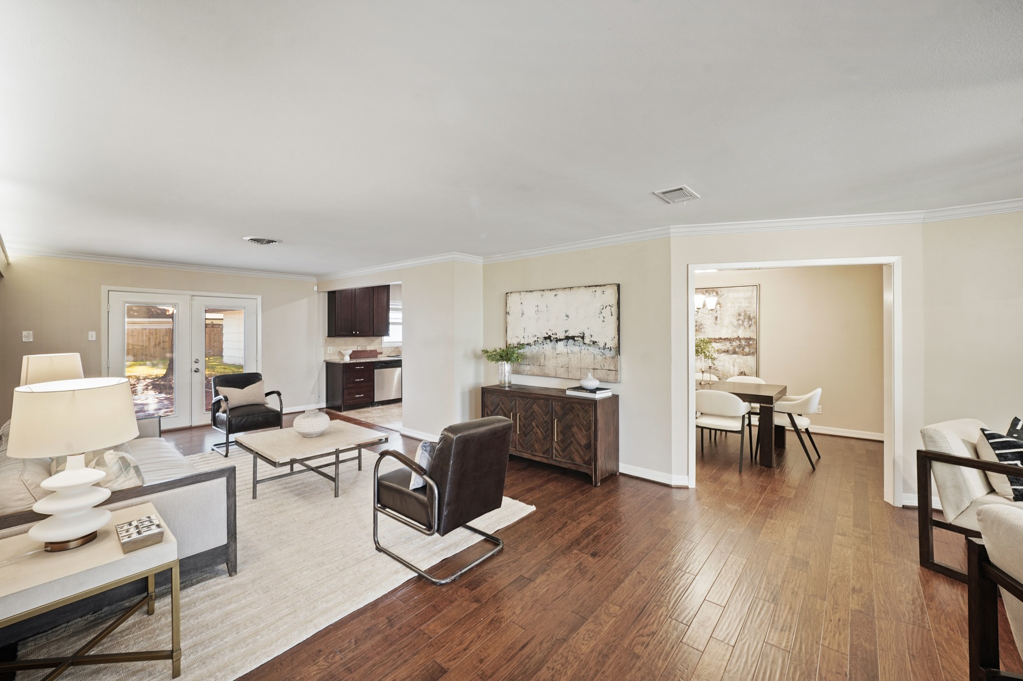5671 Sylmar Road Houston, TX 77081 - Photo 47 of 50 a living room with furniture wooden floor and a view of kitchen