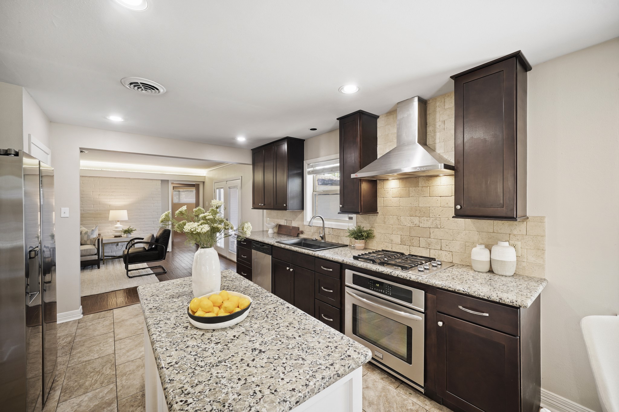 5671 Sylmar Road Houston, TX 77081 - Photo 17 of 50 a kitchen with stainless steel appliances granite countertop a stove a sink and a refrigerator
