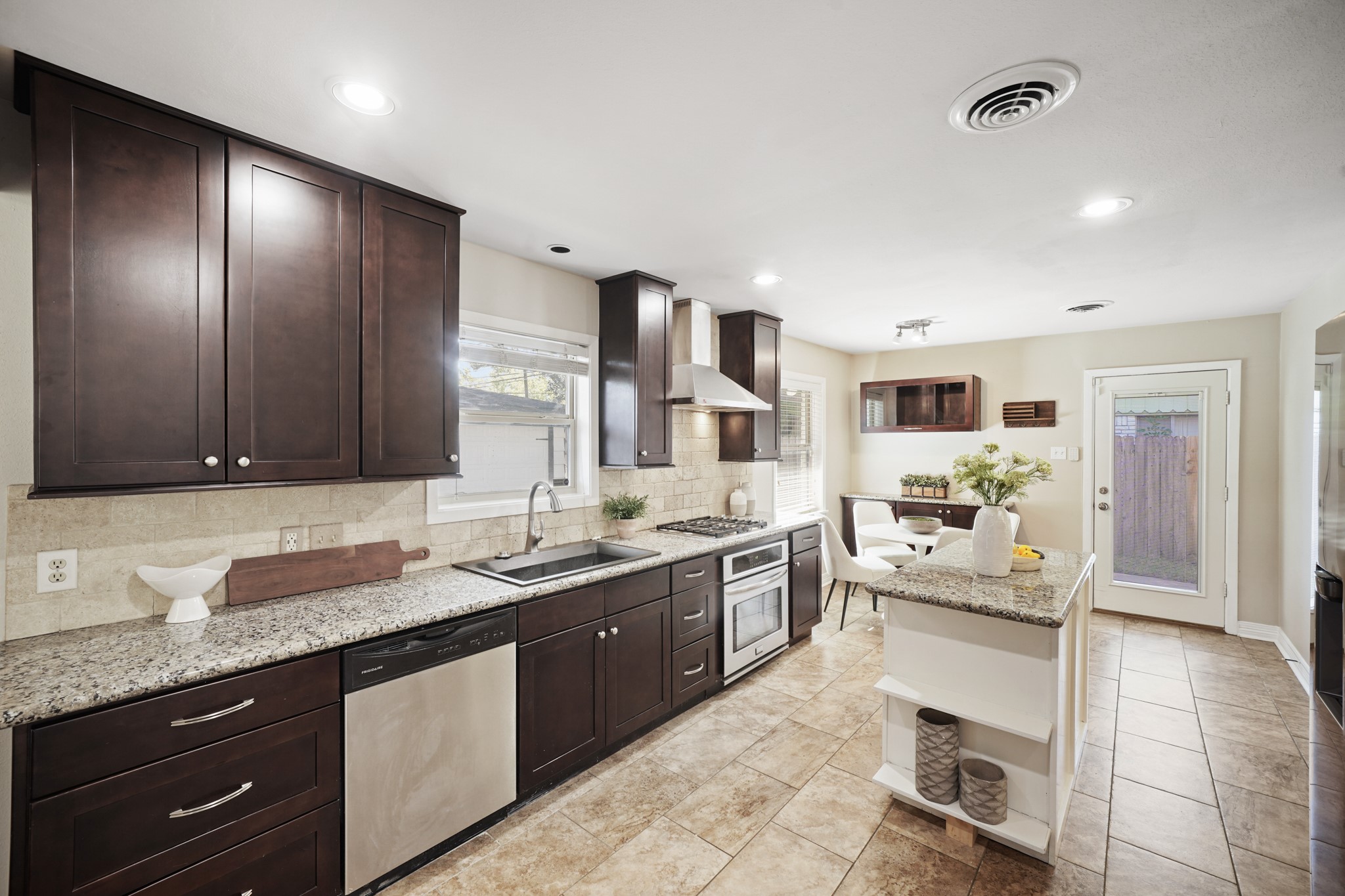 5671 Sylmar Road Houston, TX 77081 - Photo 18 of 50 a large kitchen with granite countertop a sink and cabinets