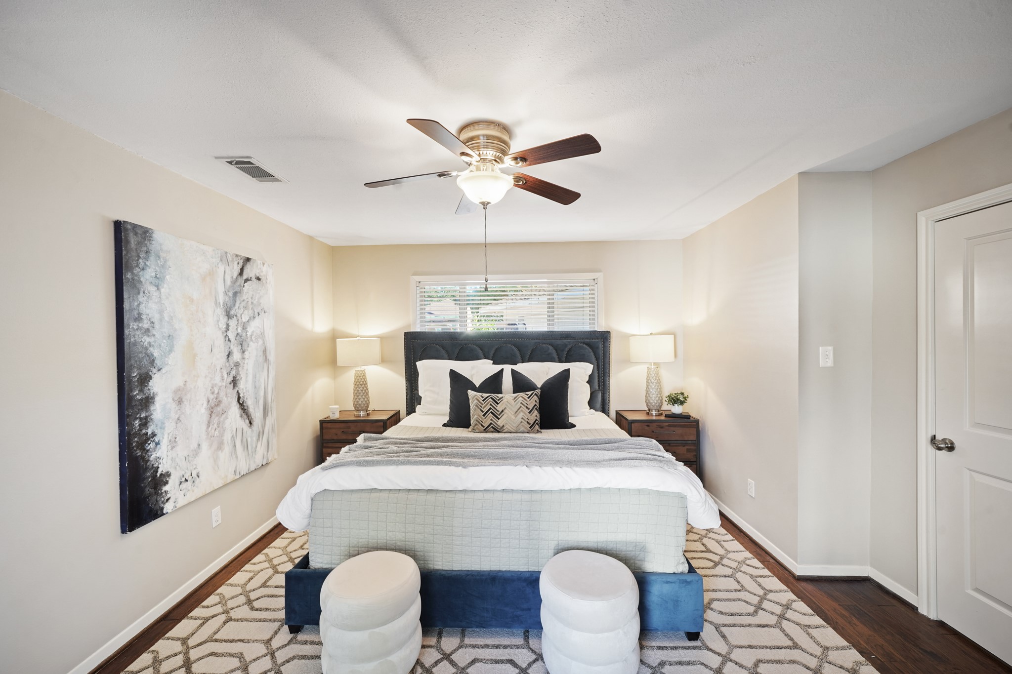 5671 Sylmar Road Houston, TX 77081 - Photo 22 of 50 a large bedroom with a bed and a chandelier