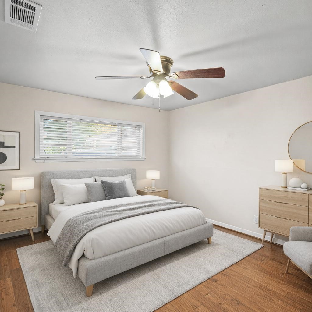 5671 Sylmar Road Houston, TX 77081 - Photo 29 of 50 a bedroom with a bed and a chandelier