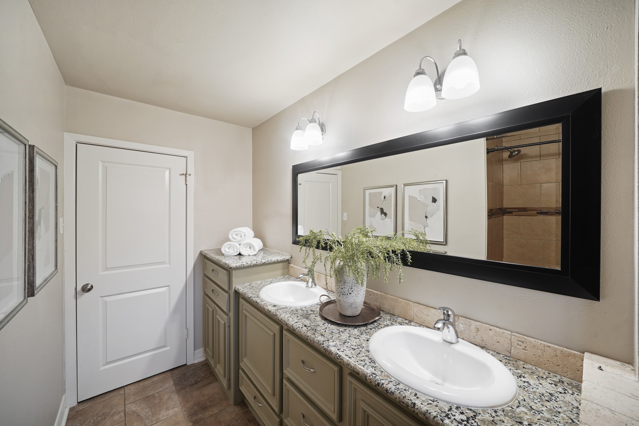 5671 Sylmar Road Houston, TX 77081 - Photo 35 of 50 a bathroom with a granite countertop sink a large mirror and vanity