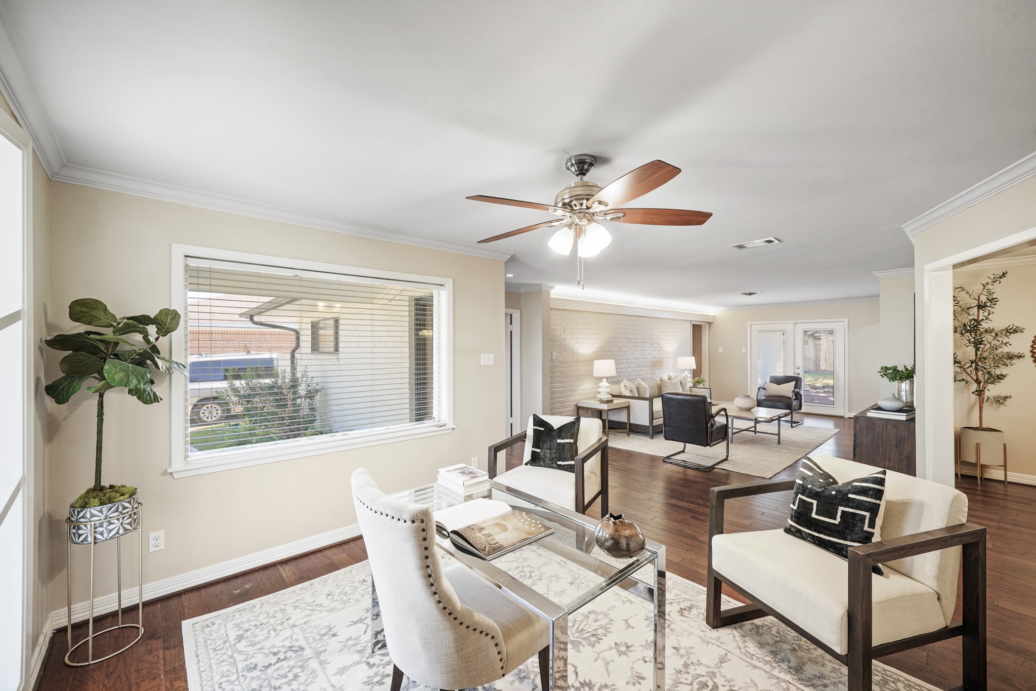 5671 Sylmar Road Houston, TX 77081 - Photo 42 of 50 a living room with furniture a chandelier and a window