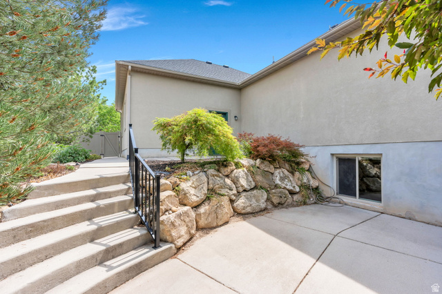 373 East Alexander Drive Elk Ridge, UT 84651 - Photo 54 of 69 Concrete staircase with a black metal handrail, leading to a paved walkway