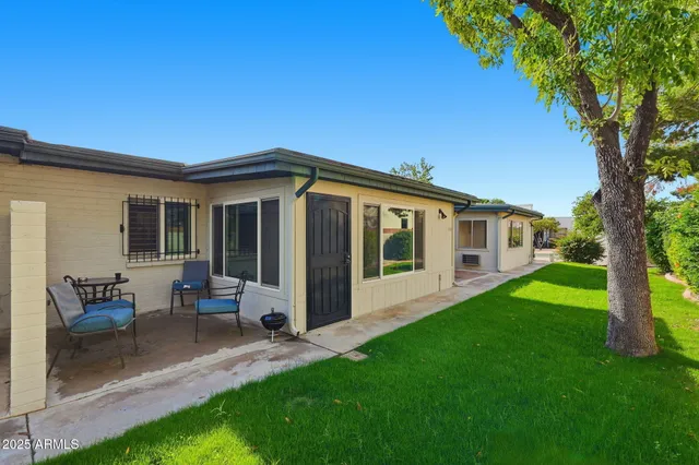 a view of a house with a backyard and a patio