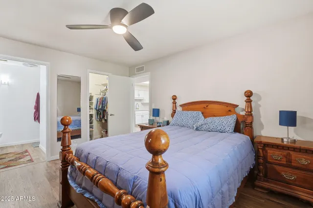 a bedroom with a bed and wooden floor