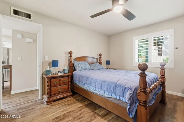 a bedroom with a bed and wooden floor