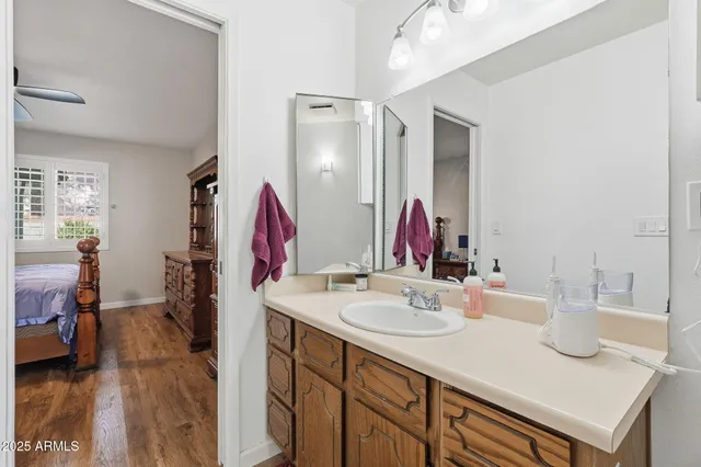 a bathroom with a sink vanity and a mirror