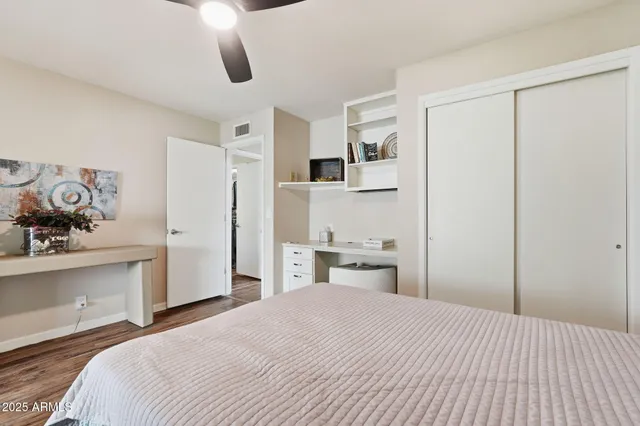 a bedroom with a bed and cabinets