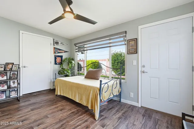 a bedroom with a bed table and a window