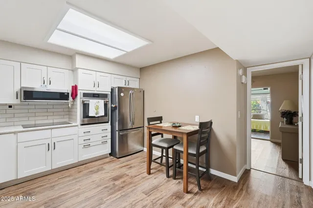 a kitchen with refrigerator cabinets and wooden floor