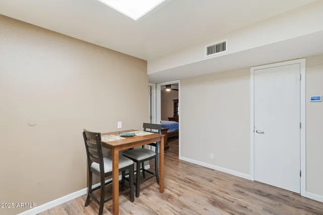 a view of a workspace with furniture and wooden floor