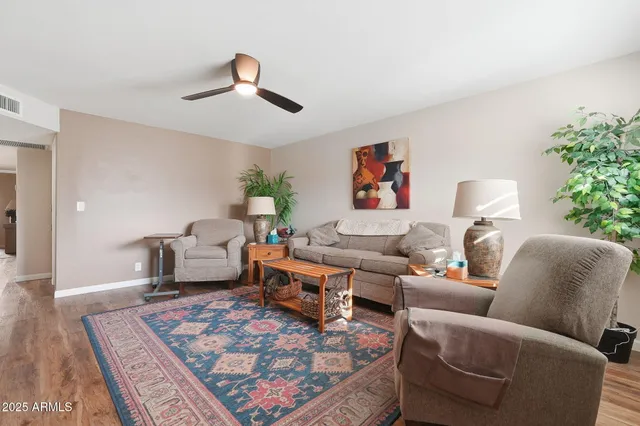 a living room with furniture and a rug