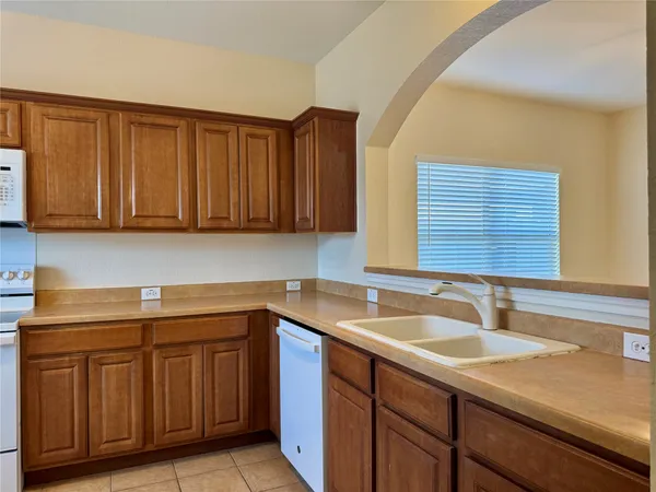 a kitchen with stainless steel appliances granite countertop a sink and cabinets