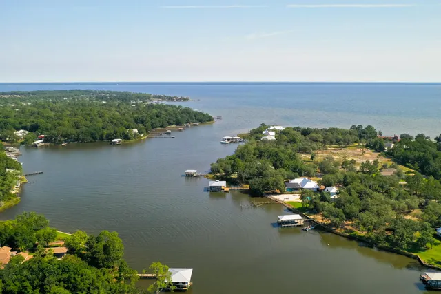 an aerial view of a houses with ocean view