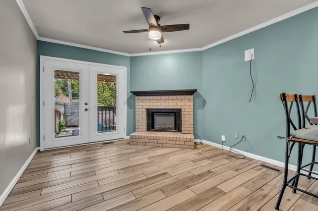 a view of an empty room with a fireplace and a window