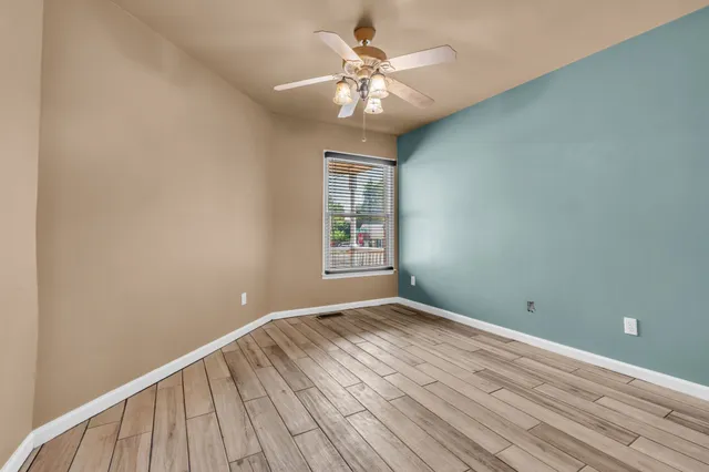 a view of an empty room and wooden floor