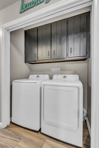 an empty room with staircase and windows