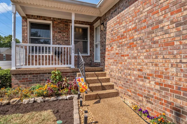 a view of a house with wooden fence