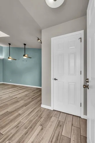 a view of a room with wooden floor
