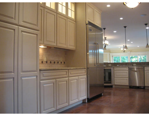 40 Rochester Road Newton, MA 02458 - Photo 11 of 21 a kitchen with kitchen island granite countertop white cabinets and stainless steel appliances