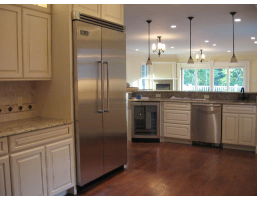40 Rochester Road Newton, MA 02458 - Photo 13 of 21 a kitchen with stainless steel appliances granite countertop a refrigerator a sink a stove and white cabinets