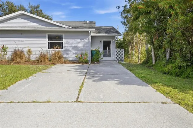 a front view of a house with a yard and a garage
