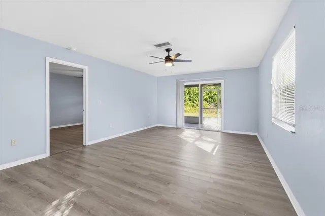 wooden floor in an empty room with a window