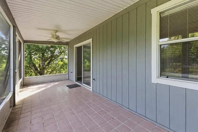 a view of a porch with a table and chairs