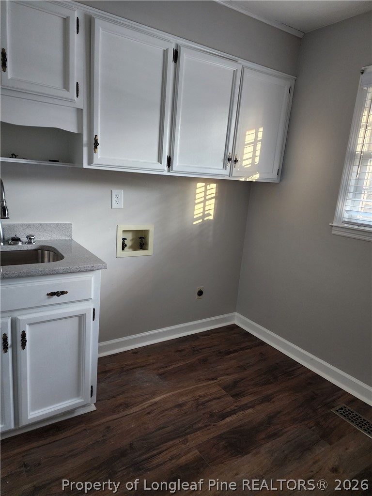 1303 Middle Road Fayetteville, NC 28312 - Photo 8 of 17 a view of cabinets with wooden floor and cabinets