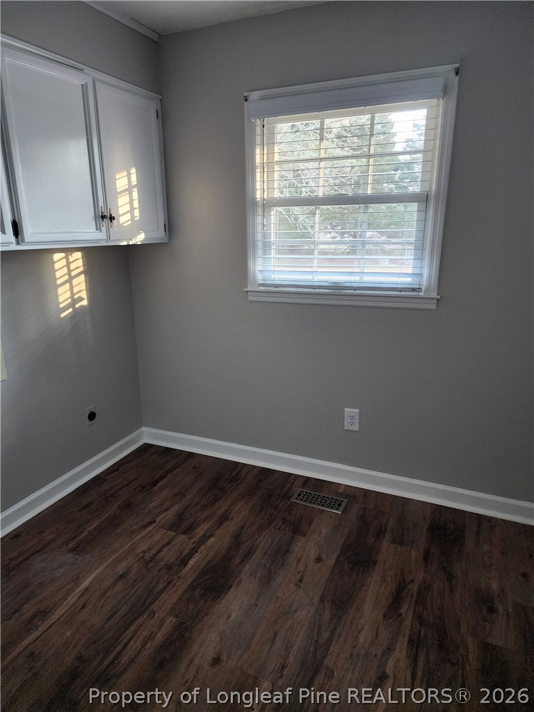 1303 Middle Road Fayetteville, NC 28312 - Photo 9 of 17 a view of an empty room with wooden floor and a window