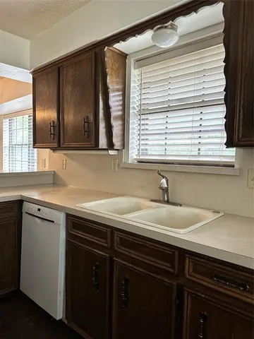 a kitchen with stainless steel appliances a stove a sink and a microwave