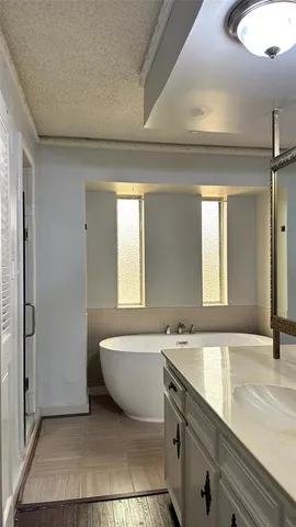 a bathroom with a bathtub sink and mirror
