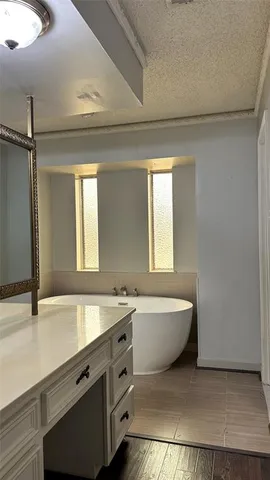 a spacious bathroom with a bathtub and a sink