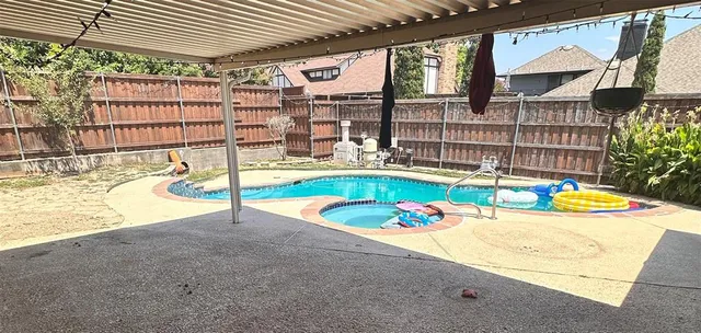 a view of a swimming pool with a patio
