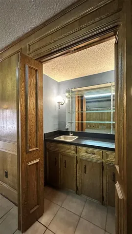 a view of kitchen with kitchen island a sink wooden floor and black appliances