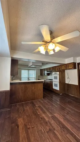 a kitchen with stainless steel appliances a stove and wooden floor