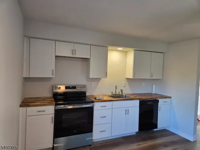 a kitchen with a sink stove and cabinets
