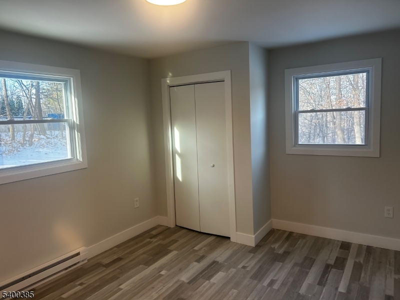 441 Rutherford Avenue Franklin, NJ 07416 - Photo 5 of 7 an empty room with wooden floor and windows
