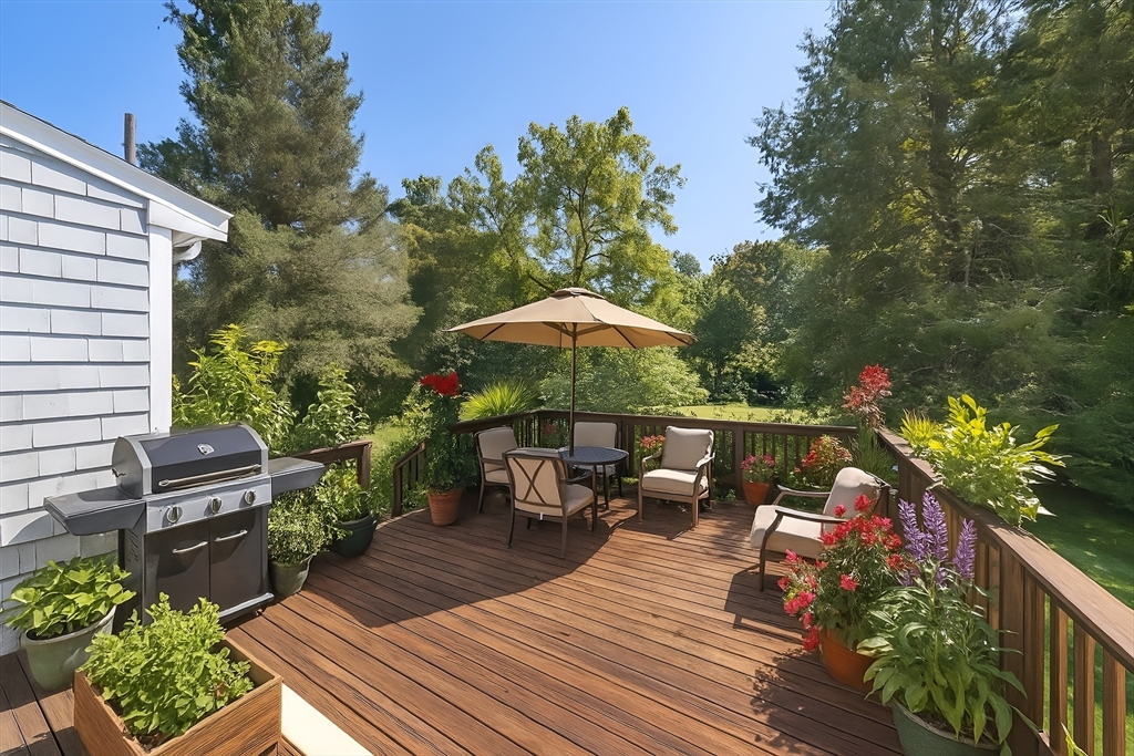 751 Brook Road Milton, MA 02186 - Photo 17 of 20 a balcony with wooden floor table and chairs