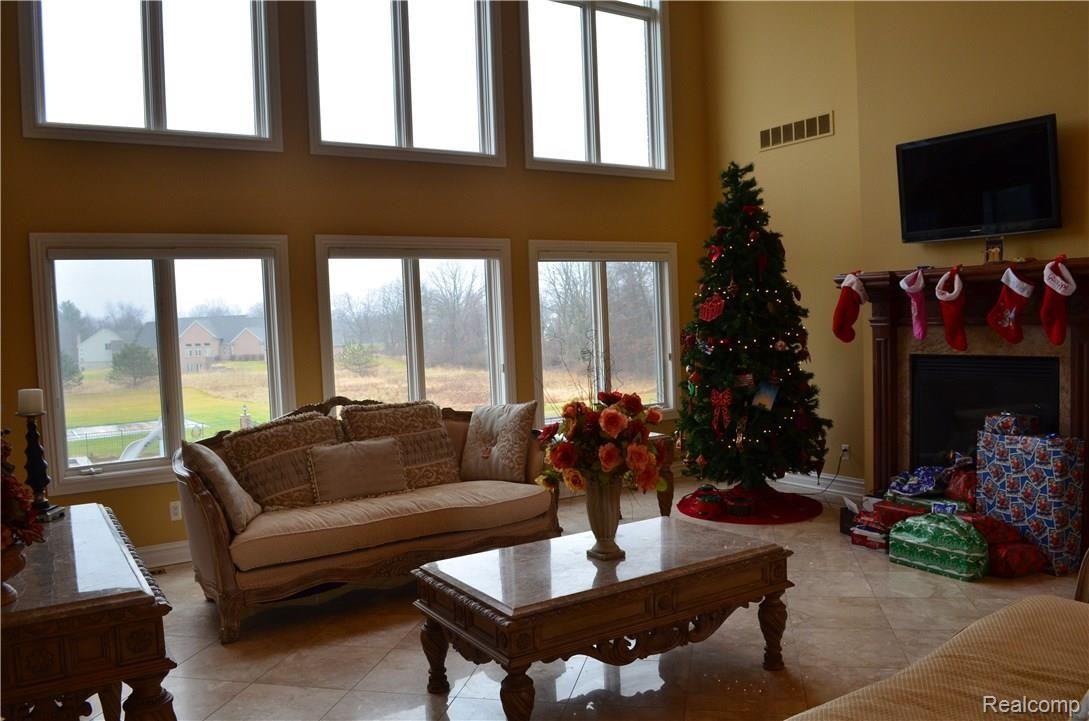 67808 Campground Road Washington, MI 48095 - Photo 28 of 77 LIVING ROOM WITH FIREPLACE AND VIEW OF HUGE BACKYARD