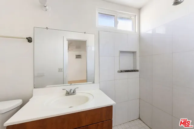 a bathroom with a granite countertop shower and a sink